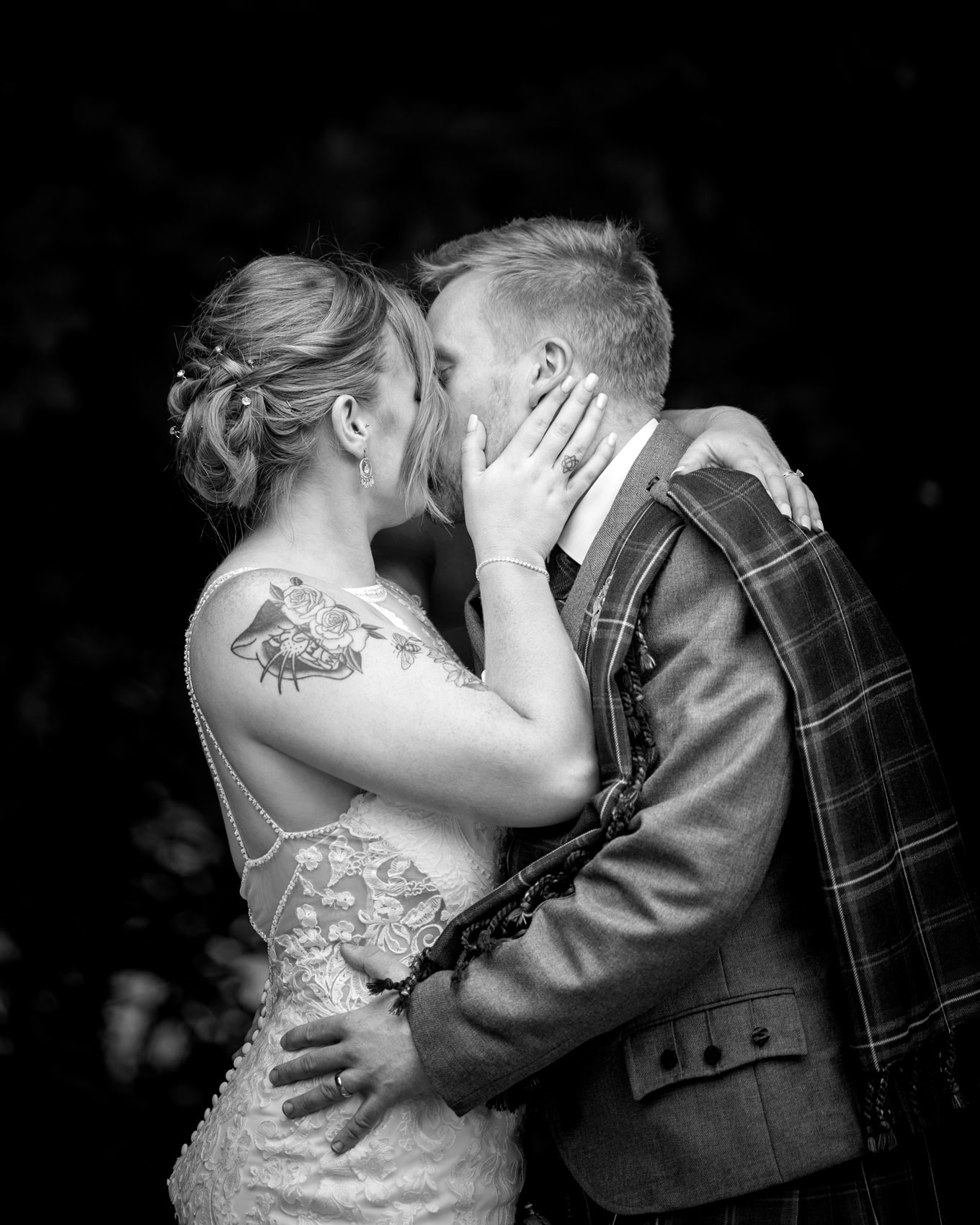 documentary black and white wedding photography of a couple kissing on their wedding day