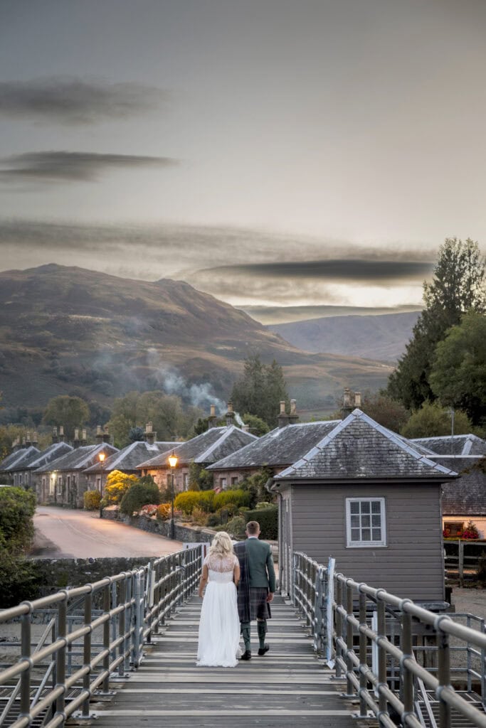 Bride and groom through Luss  near Loch Lomond Arms wedding at dusk