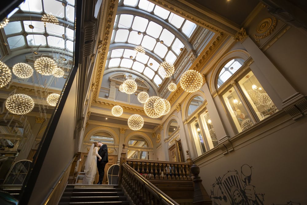 Bride and groom on grand staircase at Corinthian Glasgow wedding