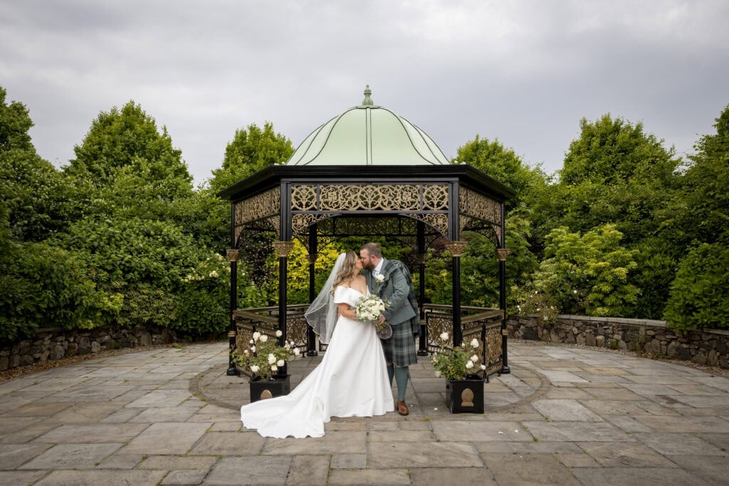 The iconic bandstand at Ingilston with a couple having a quiet moment on their wedding day