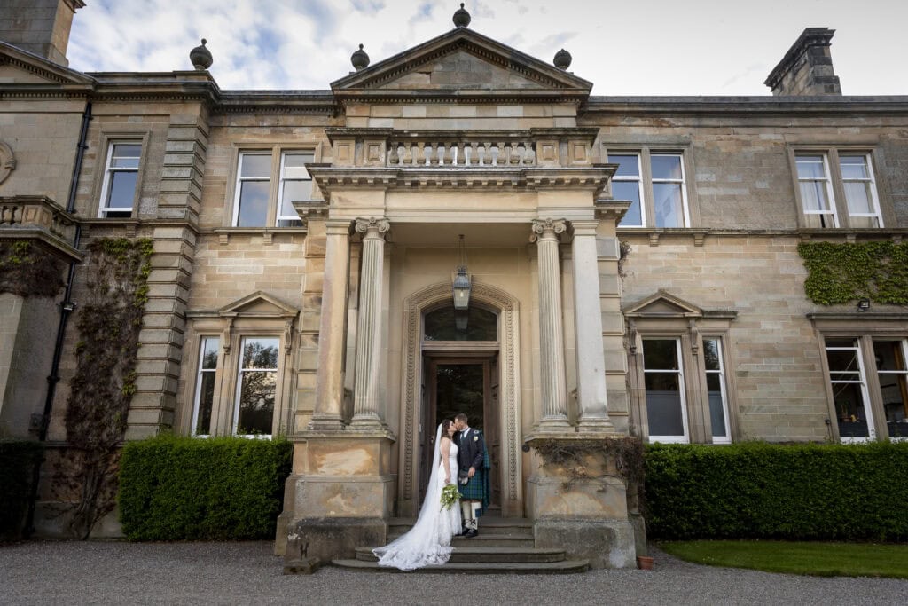 Stunning facade at Errol Park with couple on their wedding day – 1500 Photography