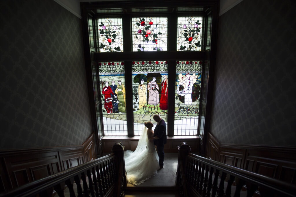 Bride and groom on staircase at One Devonshire Gardens.