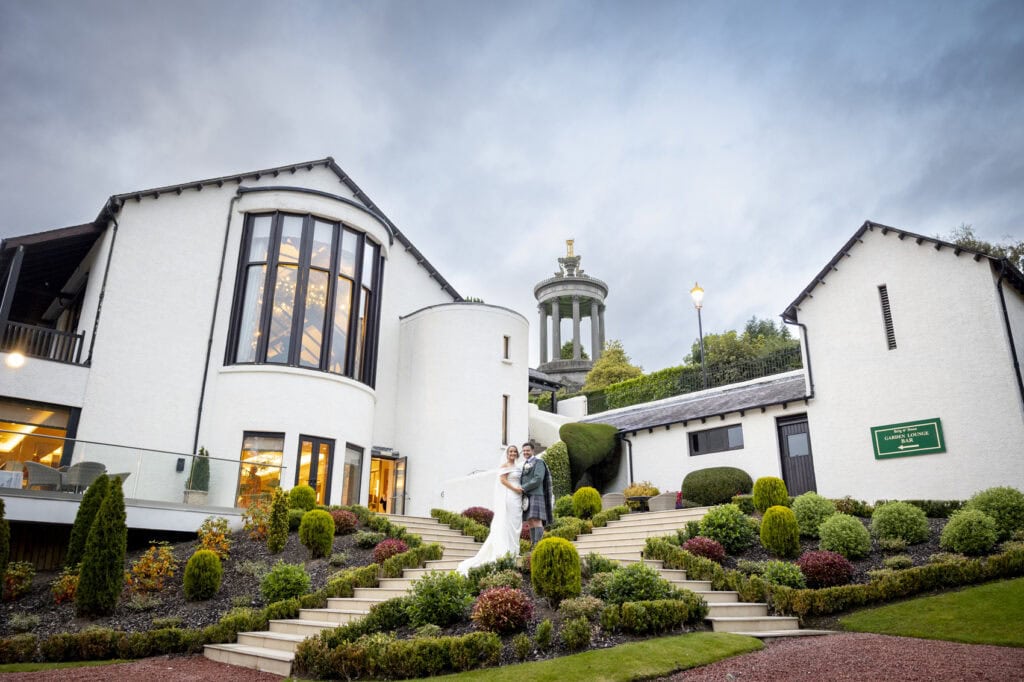 Ayrshire wedding venue Brig O'doon with the couple posing in the gardens– 1500 Photography