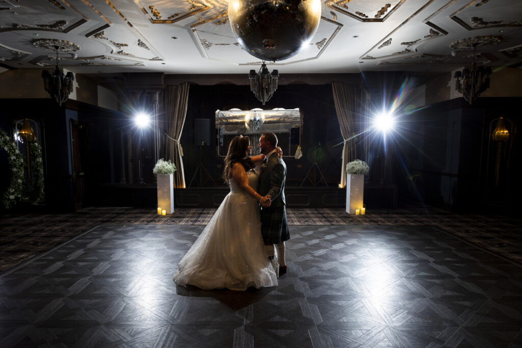 Bride and groom during their first dance at an evening wedding reception