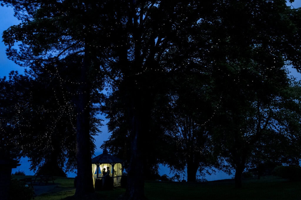 Evening reception space with fairy lights at The Cruin