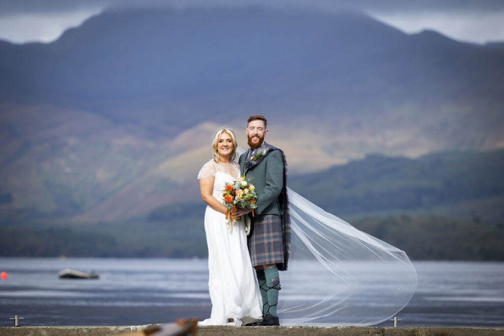 bride and groom on the jetty at luss loch lomond