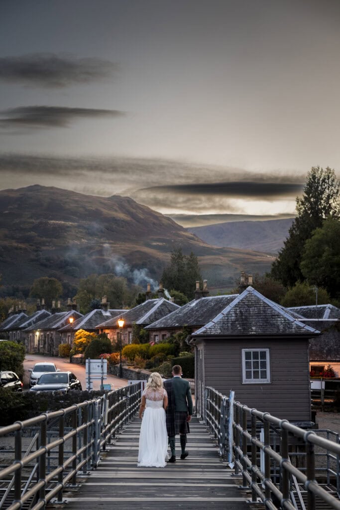 bride and groom take an evening stroll in Luss