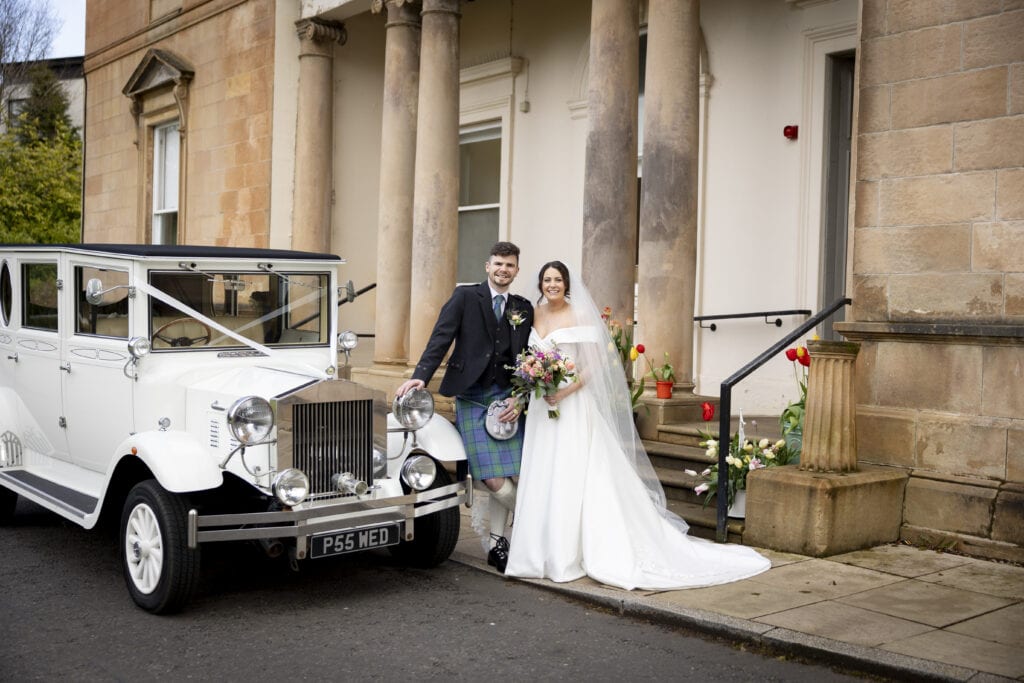 Bride and groom arriving at Kilmardinny House wedding reception